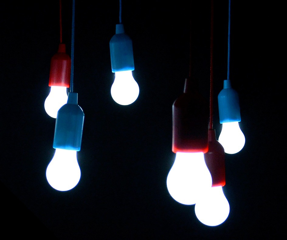 LED lightbulbs hanging in the darkness, lit up