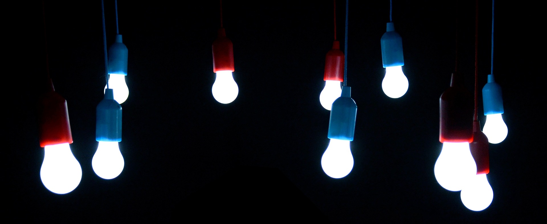 LED lightbulbs hanging in the darkness, lit up