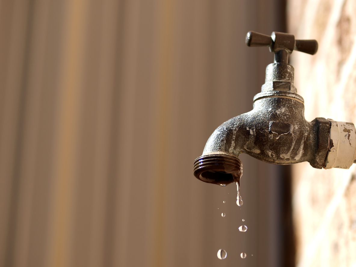 Water leaking out of a tap