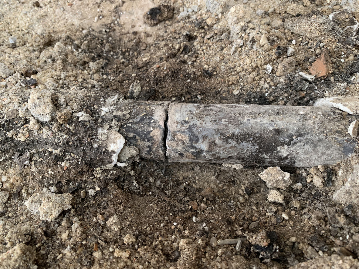 A cracked pipe in the ground