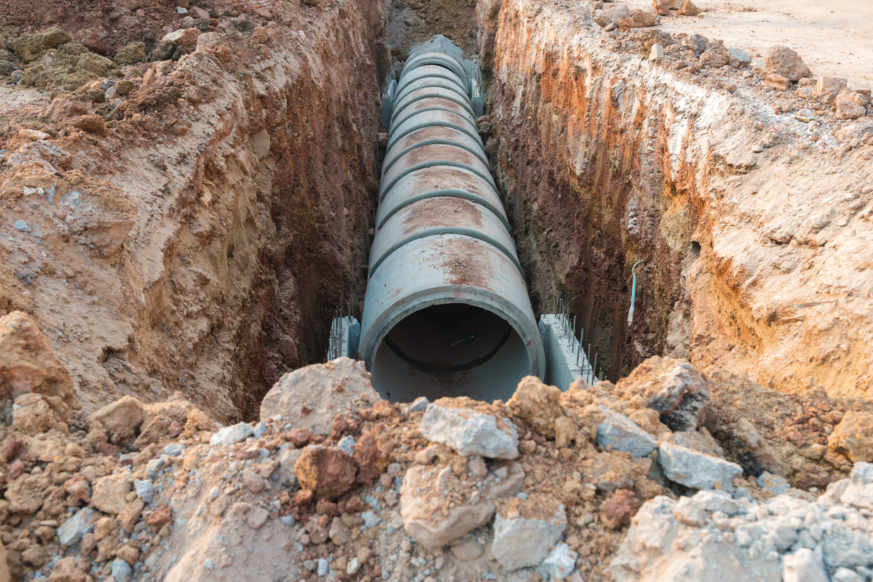 Concrete drainage pipe in the ground.