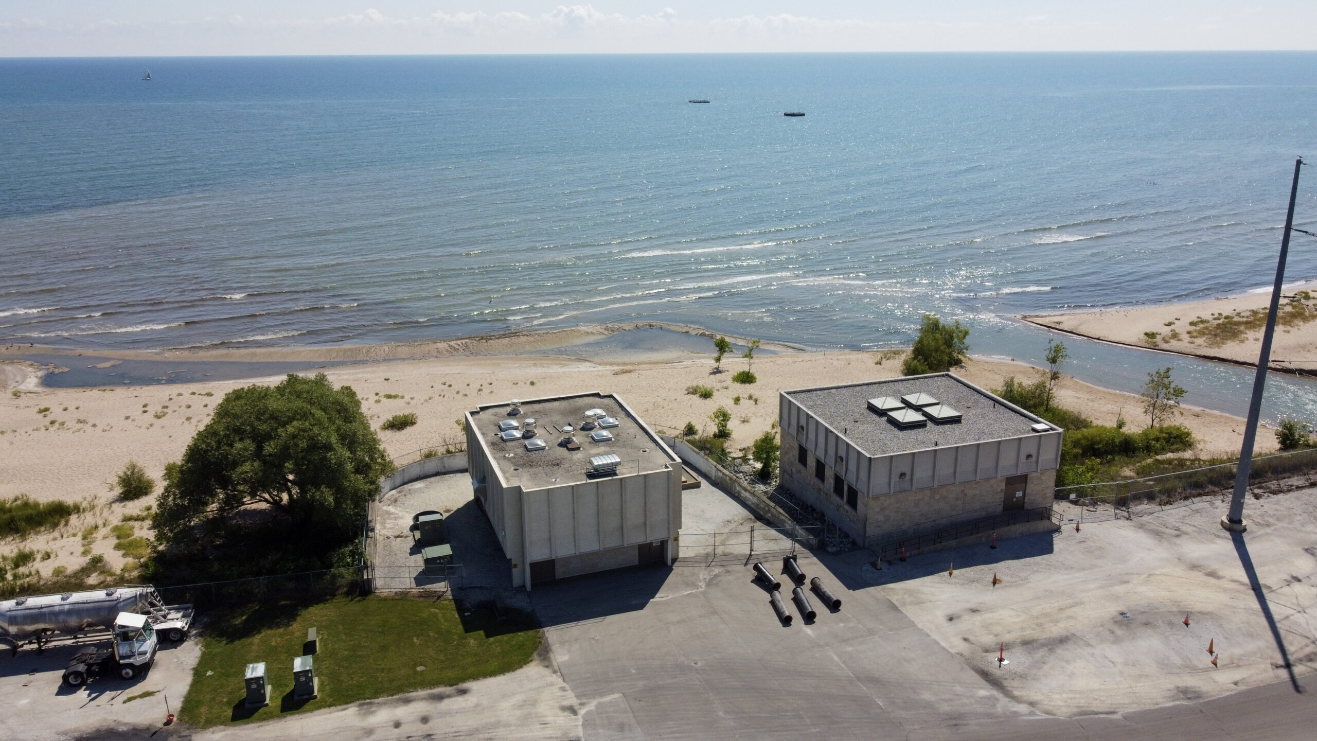 view of a lake and two water intake buildings